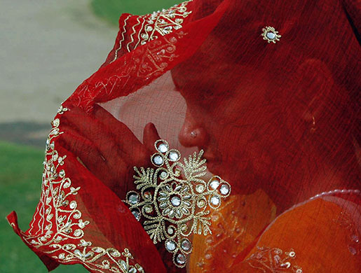 24 hours in pictures: New Delhi, India: A woman protects herself from the sun