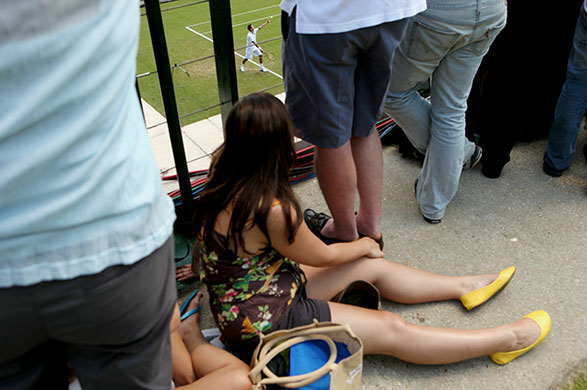 wimbledon atmosphere: Spectators watch the action on the outside courts