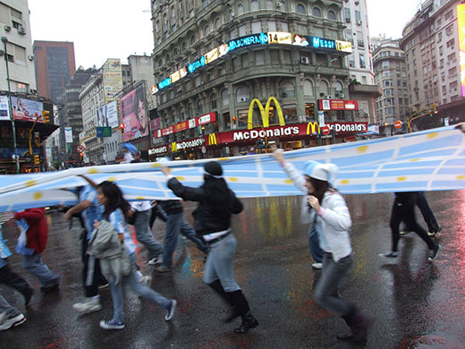 Football fans carry a huge Argentinian flag in Buenos Aires