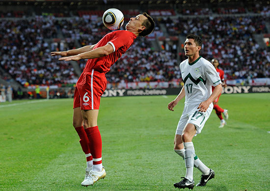 slovenia versus england: John Terry shields the ball