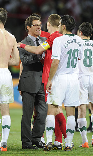 Slovenia v England: A happy looking Fabio Capello celebrates with his captain Steven Gerrard