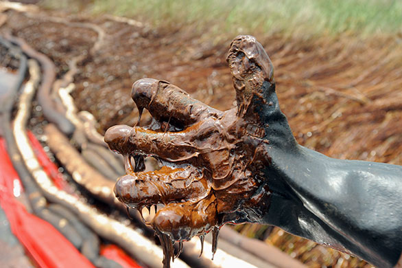 Week in Business: A glove dripping with thick oil from the BP Deepwater Horizon oil spill