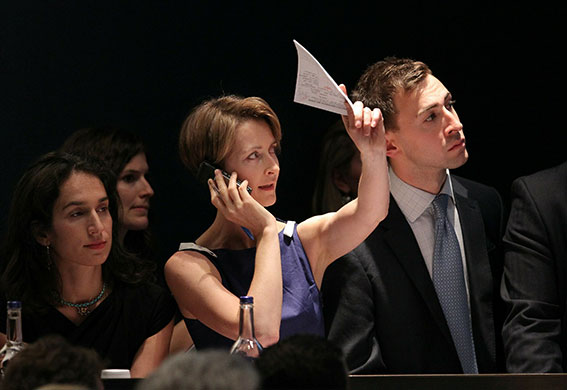 Sotheby's and Christie's: A telephone bidder makes a bid at Christie's auctioneers