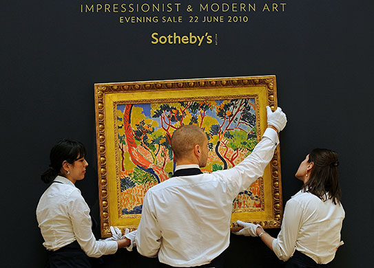 Sotheby's and Christie's: Employees hang Andre Derain work at Sotheby's