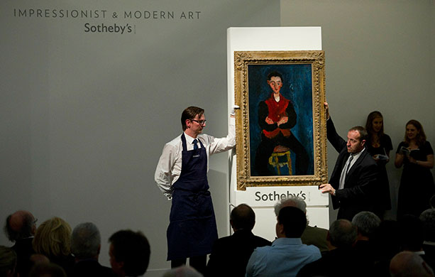 Sotheby's and Christie's: Sotheby's staff hold the Chaim Soutine painting at Sotheby's
