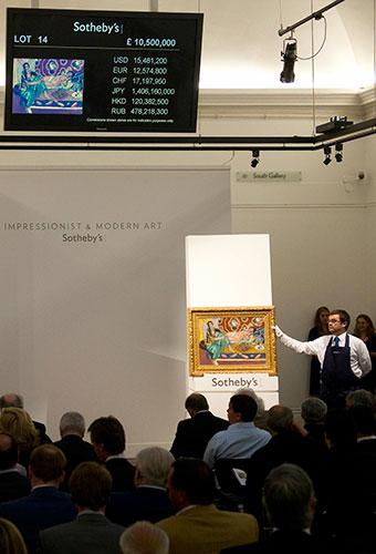 Sotheby's and Christie's: An employee holds the Henri Mattise painting at Sotheby;s