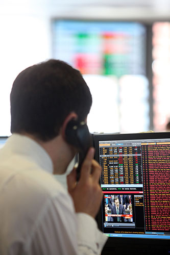 Week in Business: Stock Exchange Traders at Moneycorp in Knightsbridge watch the budget