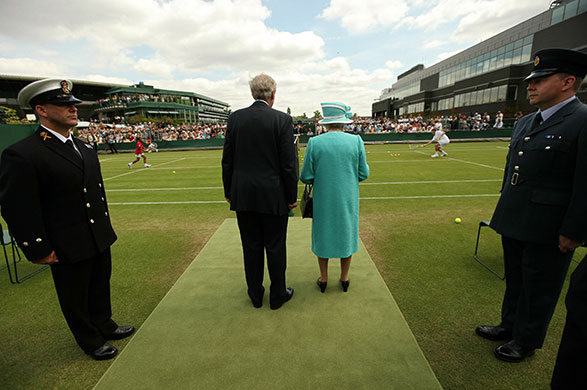 The Queen at Wimbledon: Queen Elizabeth II is escorted by Wimbledon Chairman Tim Phillips CBE