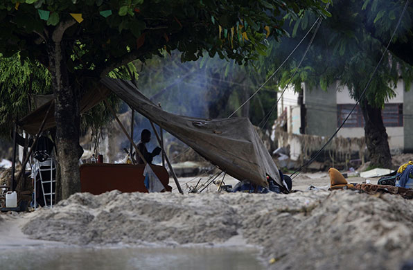 Brazil floods: A man stands at a camp set up after heavy rains in Rio Largo city