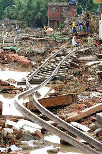 Brazil floods: Local residents sit on severely damaged railway tracks