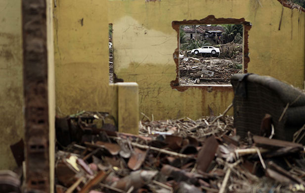 24 hours : A destroyed house is seen after heavy rains in Palmares