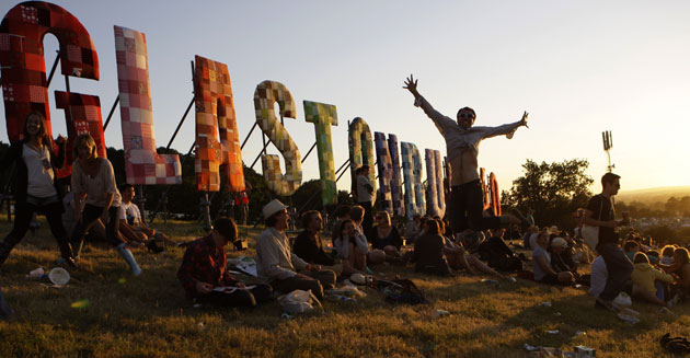 Glastonbury 2010: Man dancing at Glastonbury sign