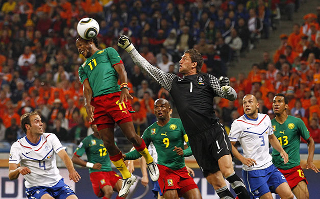 World Cup Day 14: Cameroon's Jean Makoun gets to the ball just before Maarten Stekelenburg 