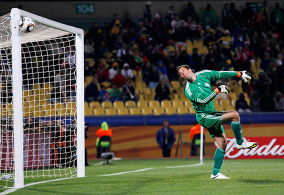 World Cup Day 14: Denmark's goalkeeper Sorensen looks at the ball as it hits the cross bar