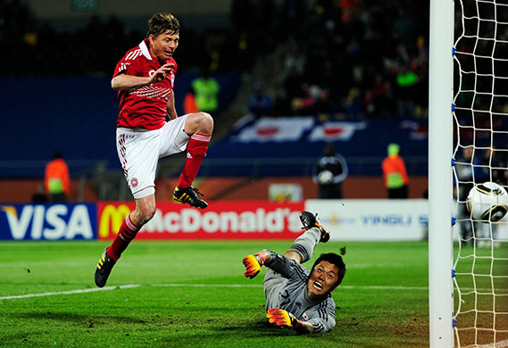World Cup Day 14: Jon Dahl Tomasson scores from the rebound after his penalty is saved
