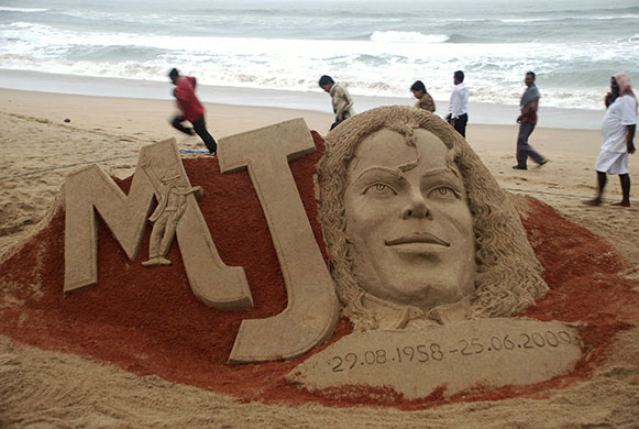 Michael Jackson memorials: People walk past a sand sculpture of Michael Jackson 