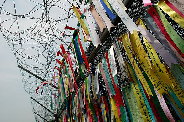 Korean War anniversary: Pro-unification messages hang on the barbed wire at the Imjingak Pavilion