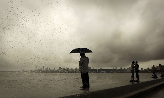 24 Hours: People at the promenade enjoy the waves lashing at the shore in Mumbai
