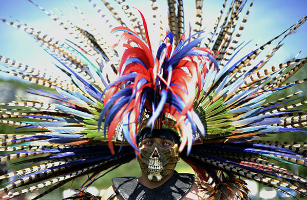 24 Hours: An Aztec Indian in traditional clothing at the Danse avec la Loue festival 