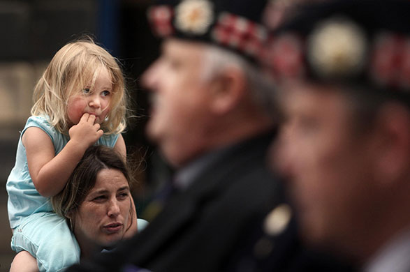 Armed Forces Day: A girl watches the Armed Forces Day parade on the Royal Mile in Edinburgh