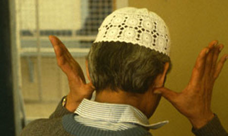 A Muslim prisoner saying prayers in his cell in Wormwood Scrubs Prison.