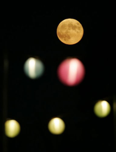 Day Four: The full moon is shown against lanterns at Glastonbury Festival