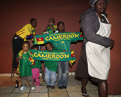 African fans in Jo'burg: Young Cameroon fans show off their scarves as their team take on Japan 
