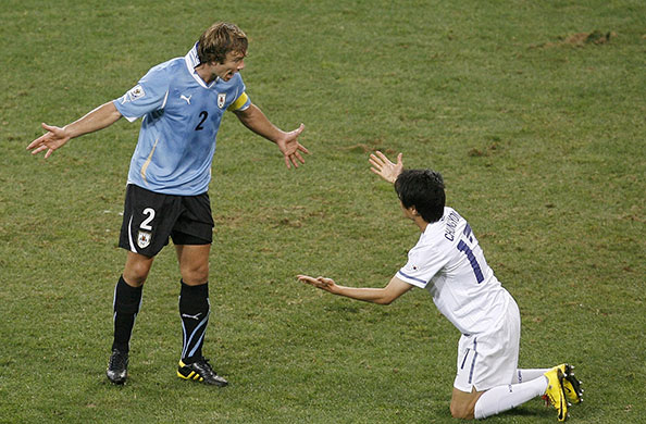 Knockout stages day 1: Uruguay's Diego Lugano, left, argues with South Korea's Chung Yong Lee