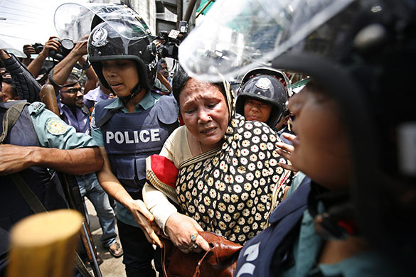 24 hours in pictures: Nababpur, Bangladesh: Security officials detain a political activist