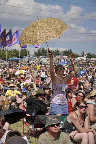 Heat: Umbrellas and parasols become a familiar sight at Glastonbury