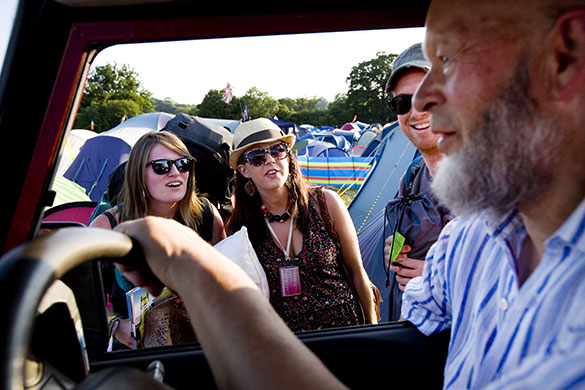 Eavis at Glastonbury: Michael Eavis greets festival goers as he drives on to the site
