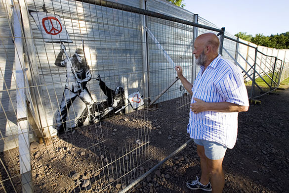 Eavis at Glastonbury: Michael Eavis stops to look at a freshly painted Banksy