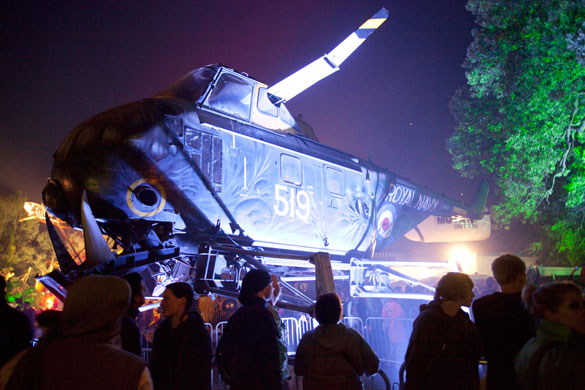 Glastonbury by night: A Royal Navy helicopter makes a surprise appearance at the Festival