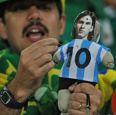 argentina v mexico: A Mexico fan puts pins in a voodoo doll of Lionel Messi
