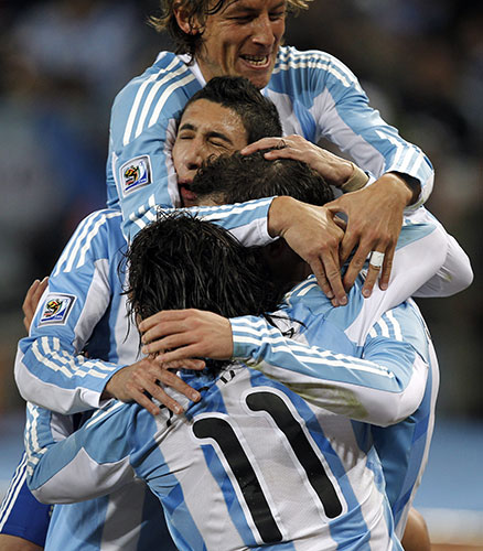 argentina v mexico: Gonzalo Higuain is mobbed after he scores Argentina's second goal