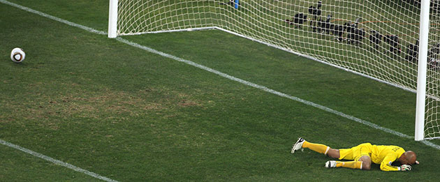 argentina v mexico: Oscar Perez lies dejected after being beaten by Tevez's shot