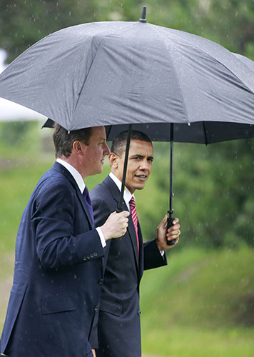 David Cameron at G8: President Barack Obama and Prime Minister David Cameron walk in the rain
