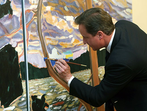 David Cameron at G8: Prime Minister David Cameron adds a few paint strokes to a painting 