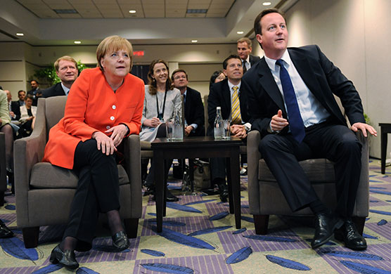 David Cameron at G8: David Cameron and Angela Merkel watch the World Cup football match