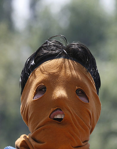 24 hours in pictures: A masked protester in Srinagar, India