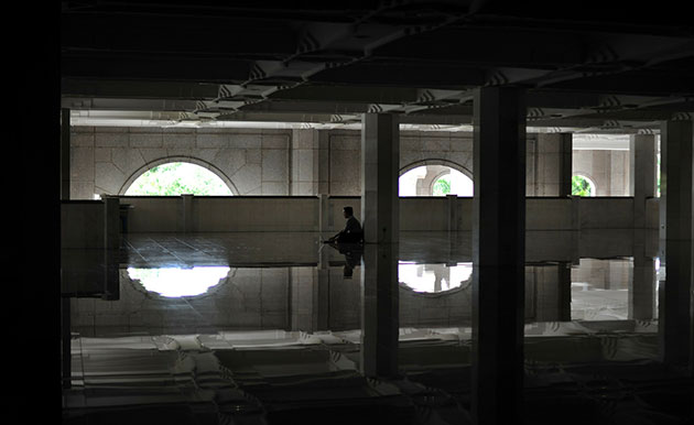 24 hours in pictures: Kuala Lumpur, Malaysia: A man works on his laptop in a mosque