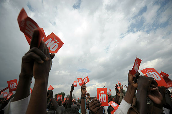 24 hours in pictures: Kenyans hold up 'Vote no' flyers during a rally