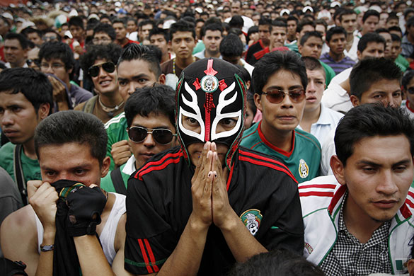 24 hours in pictures: Football fans watch the World Cup match between Mexico and Argentina
