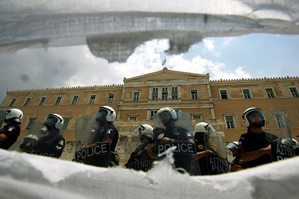 Greece protests: Riot police blockade the entrance of the Greek Parliament in Athens
