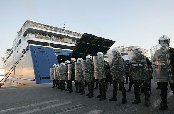 Greece protests: Riot police on duty in the port of Piraeus during a strike