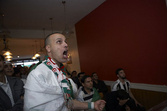 Fans network: Algeria fan watching Algeria play England in Finsbury Park, London