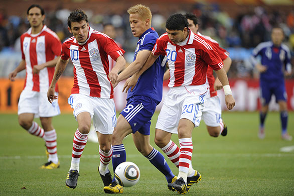 Paraguay v Japan: Keisuke Honda is tackled by Paraguay defenders