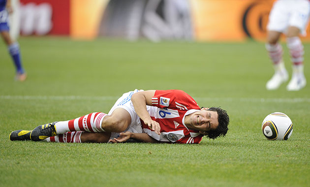 Paraguay v Japan: Carlos Bonet winces after getting fouled