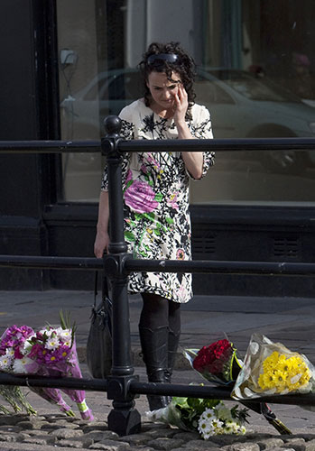 Cumbria shootings: A woman looks at flowers laid in tribute to the victims