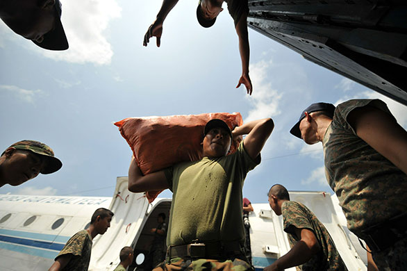 24 hours: Retalhuleu, Guatemala: Guatemalan soldiers load food supplies